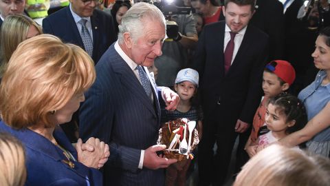 Prince Charles and Princess Margaret, the Custodian of the Romanian Crown, offer presents to Ukrainian refugees during a visit at a donation center in Bucharest, Romania on Wednesday.