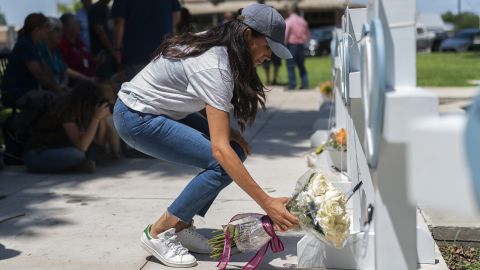 Meghan, Duchess of Sussex leaves flowers at the memorial site.