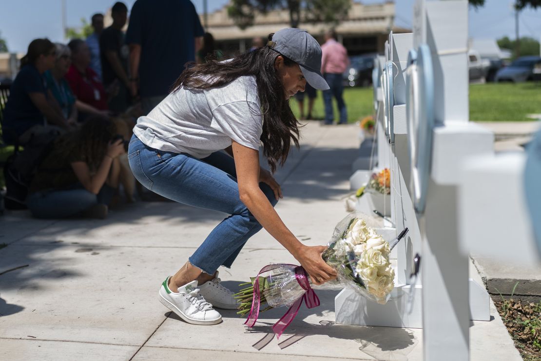 Meghan, Duchess of Sussex leaves flowers at the memorial site.