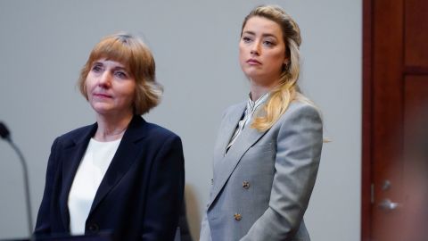 Amber Heard stands with her attorney attorney Elaine Bredehoft on Friday.