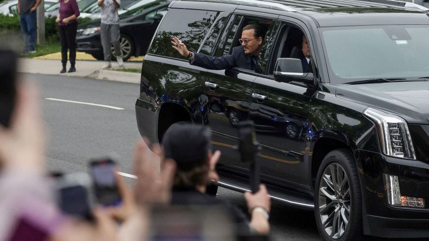 Actor Johnny Depp waves to fans as he arrives at the Fairfax County Circuit Courthouse for his defamation trial against his ex-wife Amber Heard, in Fairfax, Virginia, U.S., May 27, 2022. REUTERS/Evelyn Hockstein     TPX IMAGES OF THE DAY
