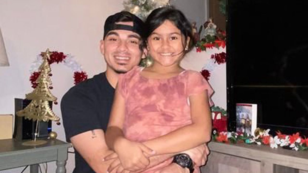 Amerie Jo Garza, 10, eiyh her stepfather, Angel Garza.
