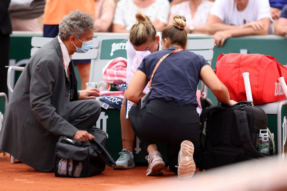Halep receives medical attention during her second-round match.