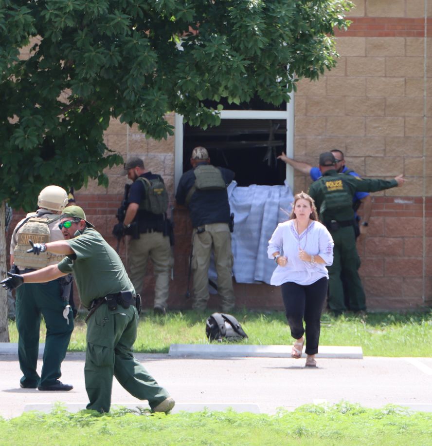 People work to get the students out from the window.