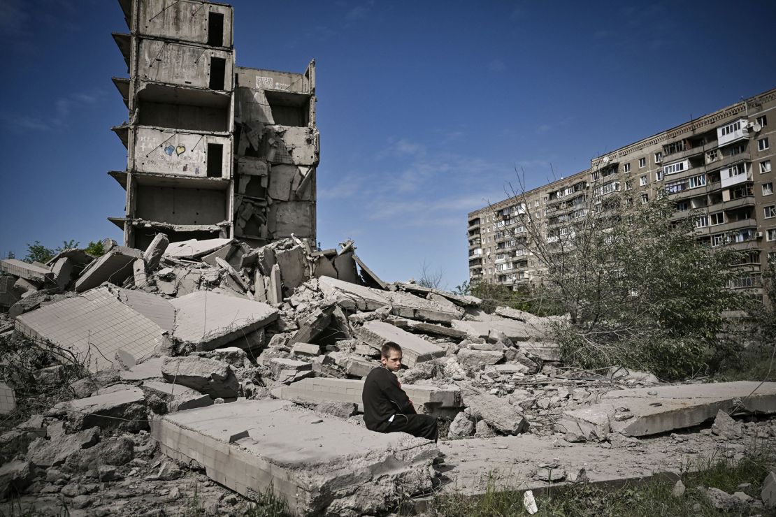 A boy sits on the rubble of a building hit in a strike on Kramatorsk, a city in the Donetsk region.