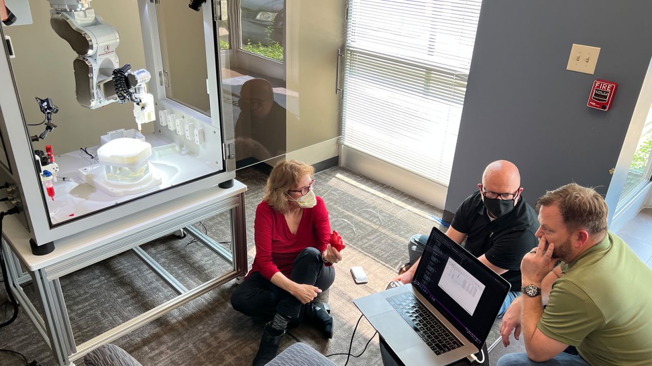 Dr. Doris Taylor (left) is teaching BAB the robot how to properly inject stem cells into a ghost heart.