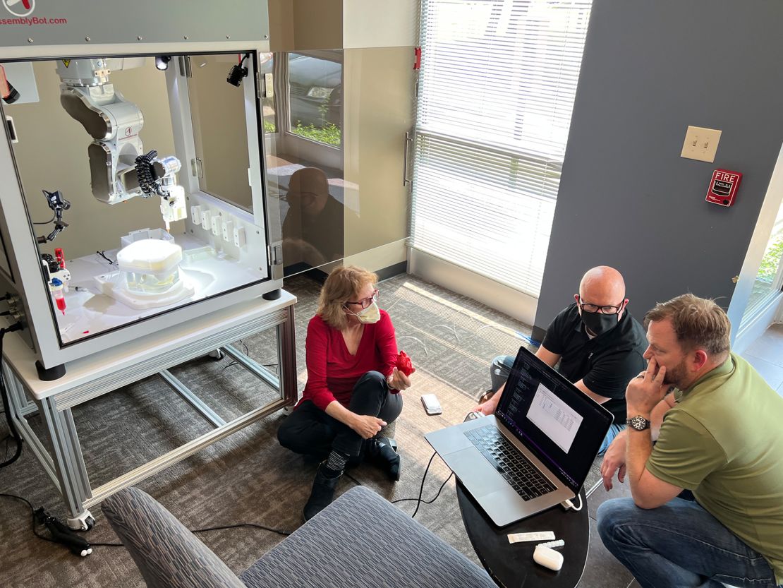 Dr. Doris Taylor (left) is teaching BAB the robot how to properly inject stem cells into a ghost heart.