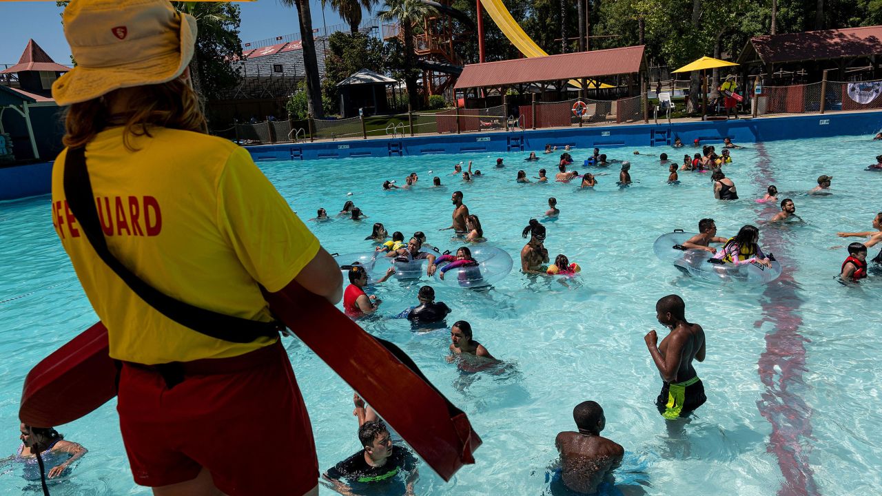 A lifeguard watches visitors swim in the Breaking Beach wave pool at the Raging Waters Sacramento water park in California, on June 28, 2021. 