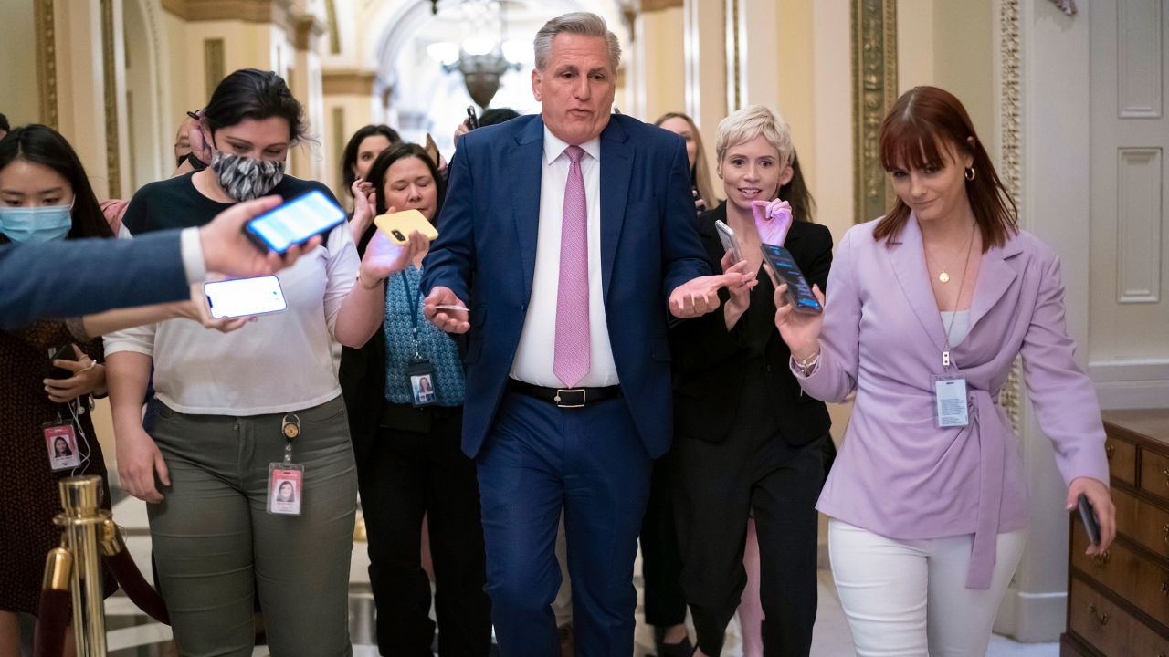 House Minority Leader Kevin McCarthy, a California Republican, heads to his office surrounded by reporters after House investigators issued a subpoena to him and four other GOP lawmakers, on May 12, 2022. 
