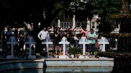 People pay their respects at a memorial site for the victims killed in this week's elementary school shooting in Uvalde, Texas, Thursday, May 26, 2022. 