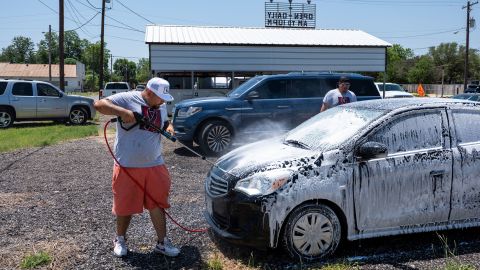 Omar Rodriguez organized a car wash and food sale to raise money. He wants to raise $21,000 -- $1,000 for every family who has lost a loved one.