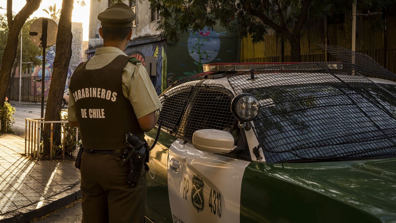 A police officer patrols Santiago's Yungay neighborhood in April.