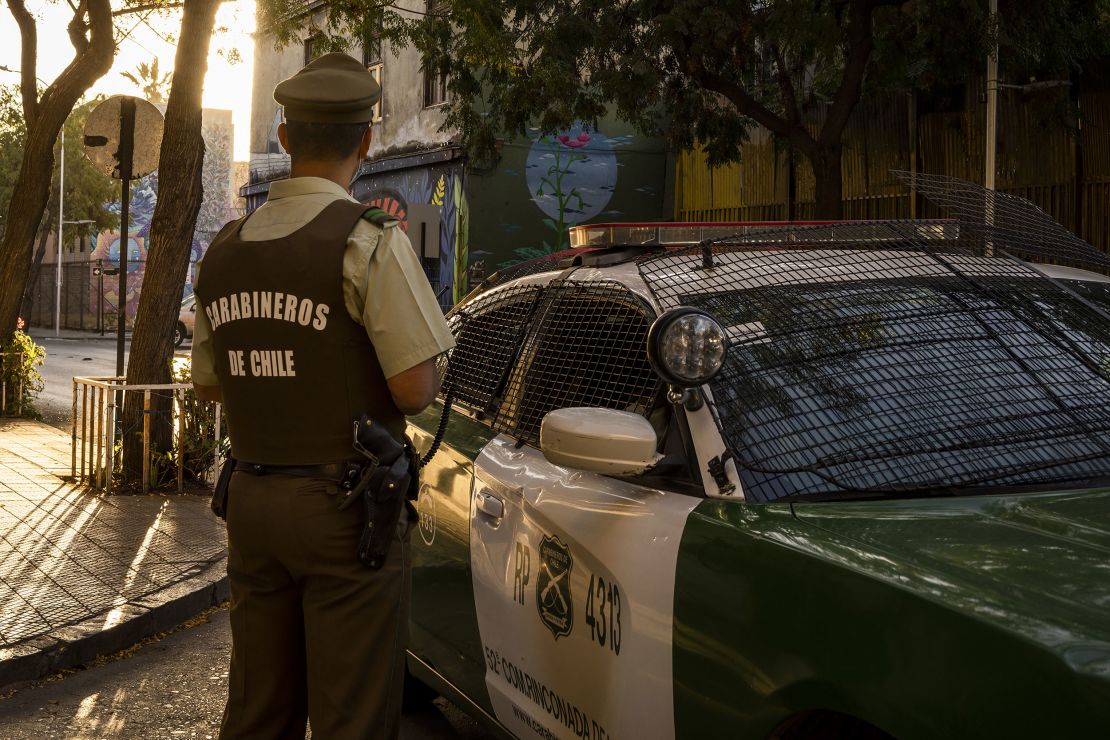 A police officer patrols Santiago's  Yungay neighborhood in April. 