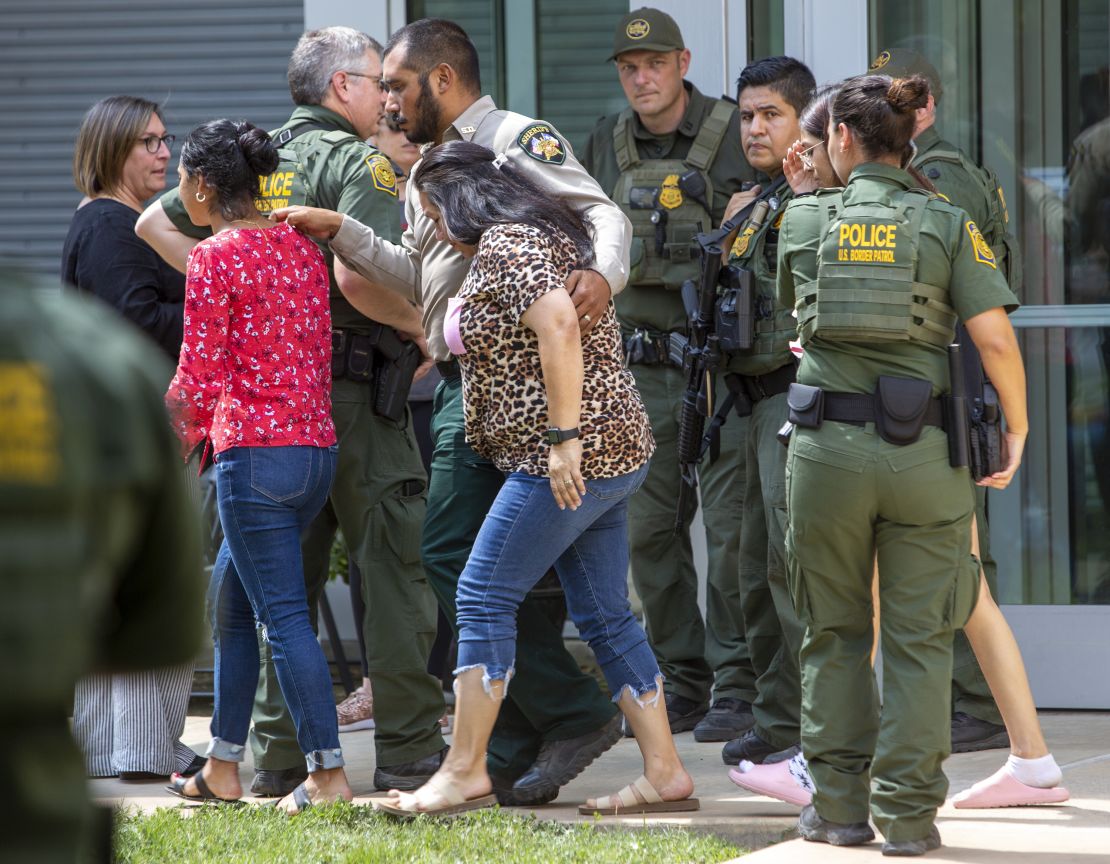 People leave the Uvalde Civic Center following the shooting at Robb Elementary School.