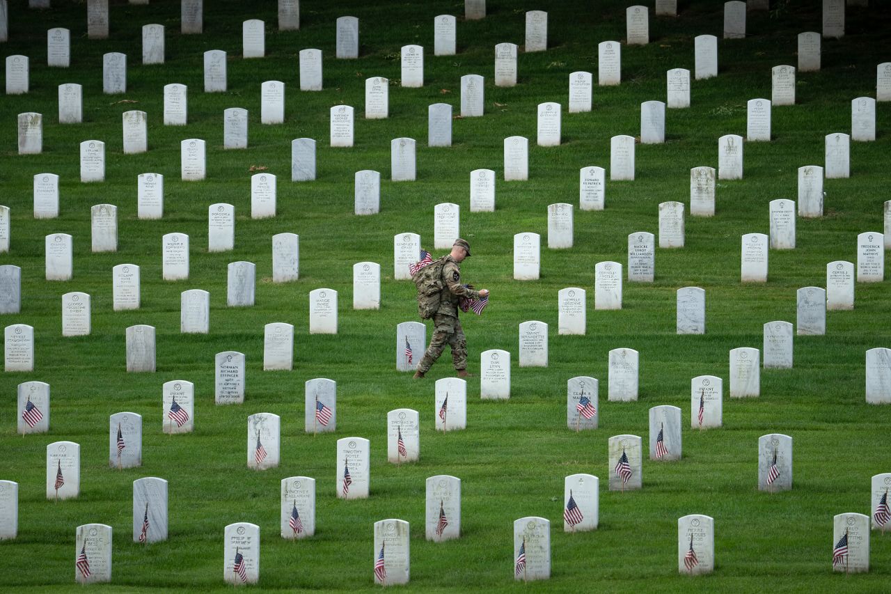 A member of the US Army's 3rd US Infantry Regiment places flags at Arlington National Cemetery on Thursday, May 26, a few days ahead of Memorial Day. <a href="http://www.cnn.com/2022/05/26/world/gallery/photos-this-week-may-19-may-26/index.html" target="_blank">See last week in 45 photos.</a>