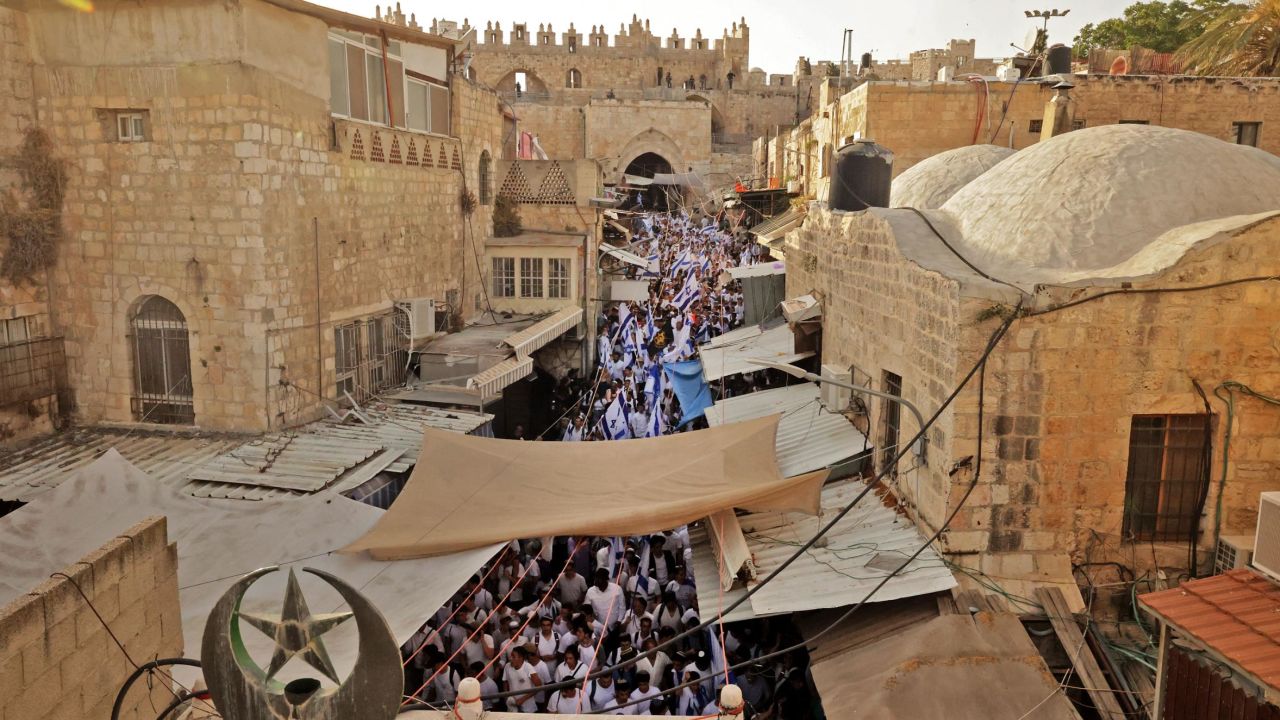 Demonstrators gather with Israeli flags after crossing through the Damascus Gate on May 29, 2022.