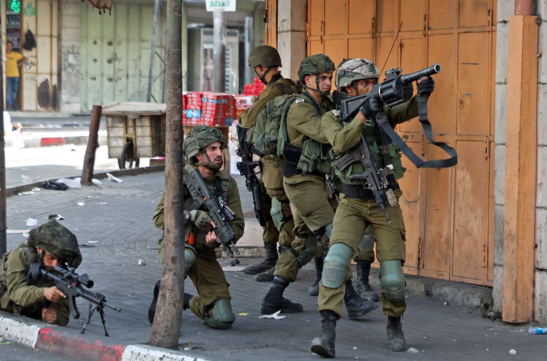 Israeli army soldiers take aim during clashes with protesters following a demonstration to denounce the annual "flag march," on May 29, 2022.