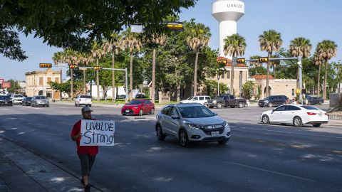 Alex Covarrubias carries a sign downtown that reads, "Uvalde Strong," in Uvalde, Texas on Sunday, May 29, 2022. 
