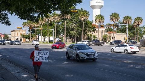 Alex Covarrubias carries a sign downtown that reads, "Uvalde Strong," in Uvalde, Texas on Sunday, May 29, 2022.