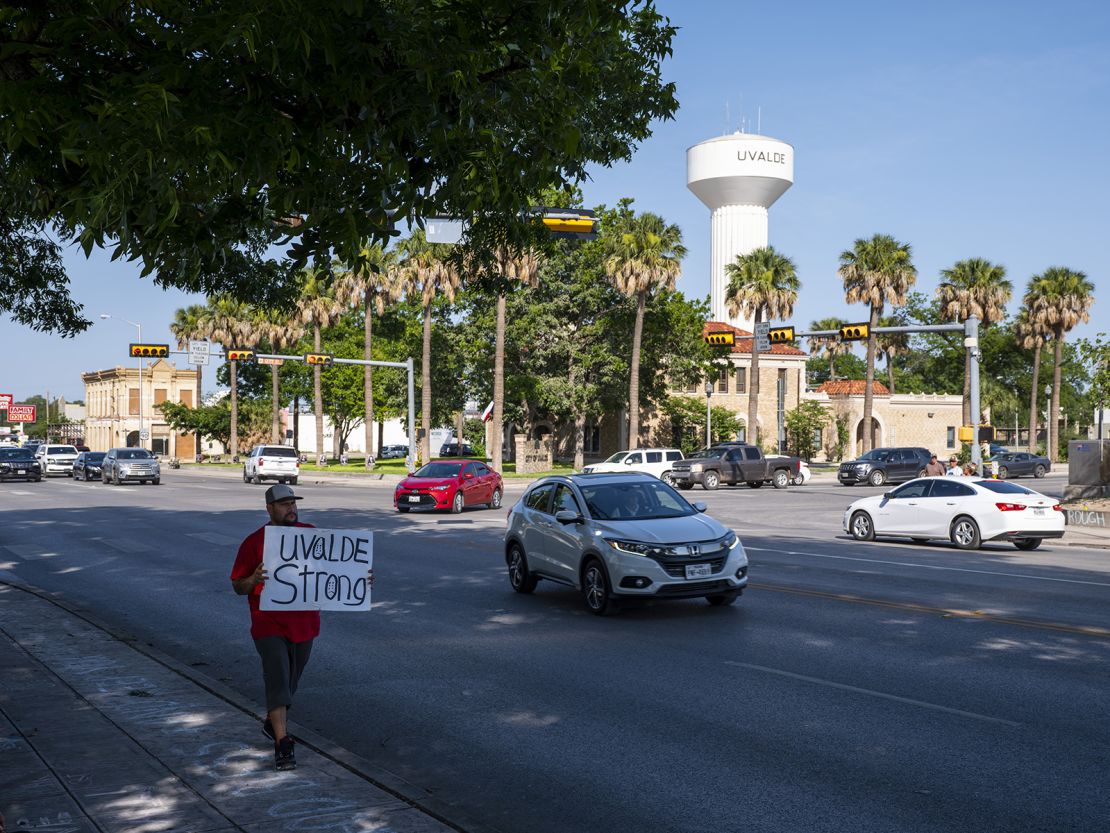 Alex Covarrubias carries a sign downtown that reads, "Uvalde Strong," in Uvalde, Texas on Sunday, May 29, 2022. 
