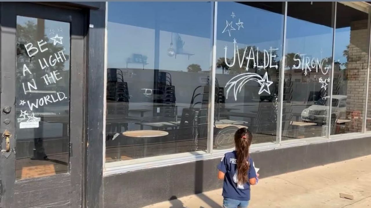 "Uvalde Strong" and other uplifting messages are written on the windows of Carlitos Way.