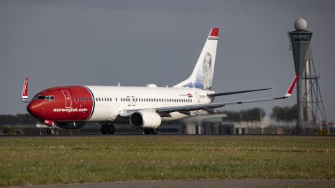 A Norwegian Boeing 737-800 aircraft departing from Amsterdam Schiphol Airport. 
