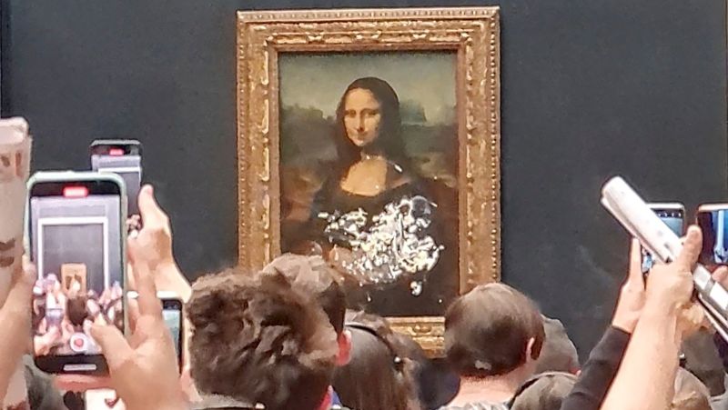 Man in disguise throws a cake at the Mona Lisa