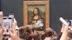 Visitors take pictures and video of the painting "Mona Lisa" after cake was smeared on the protective glass at the Lourve Museum in Paris, France May 29, 2022 in this screen grab obtained from a social media video. Twitter/@klevisl007/via REUTERS  THIS IMAGE HAS BEEN SUPPLIED BY A THIRD PARTY. MANDATORY CREDIT.