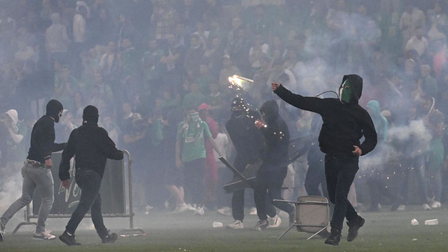A Saint-Étienne fan throws a projectile on the pitch at the Geoffroy Guichard Stadium after the club's relegation to Ligue 2.