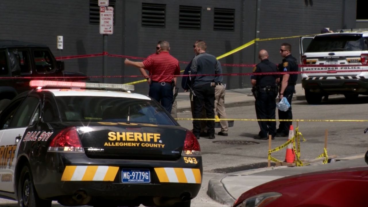 Police investigate the scene of a drive-by shooting in downtown Pittsburgh on May 29.