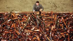 Mick Roelandts, firearms reform project manager for the New South Wales Police, looks at a pile of about 4,500 prohibited firearms in Sydney that have been handed in over the past month under the Australian government's buy-back scheme July 28. A total of 470,000 guns have been collected nationally, with owners receiving A$243 million (US$180 million) in compensation. The scheme was set up due to tighter gun laws brought in after the April 1996 Port Arthur massacre in which 35 people died when a lone gunman went on a shooting rampage.