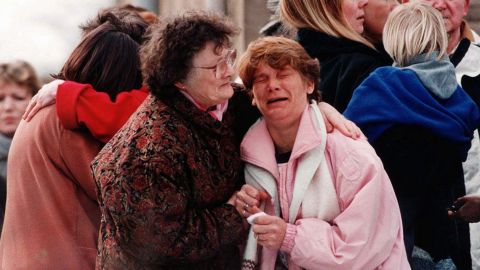 A group of relatives near the elementary school in Dunblane, Scotland, where a gunman killed 16 children and one teacher in 1996.  
