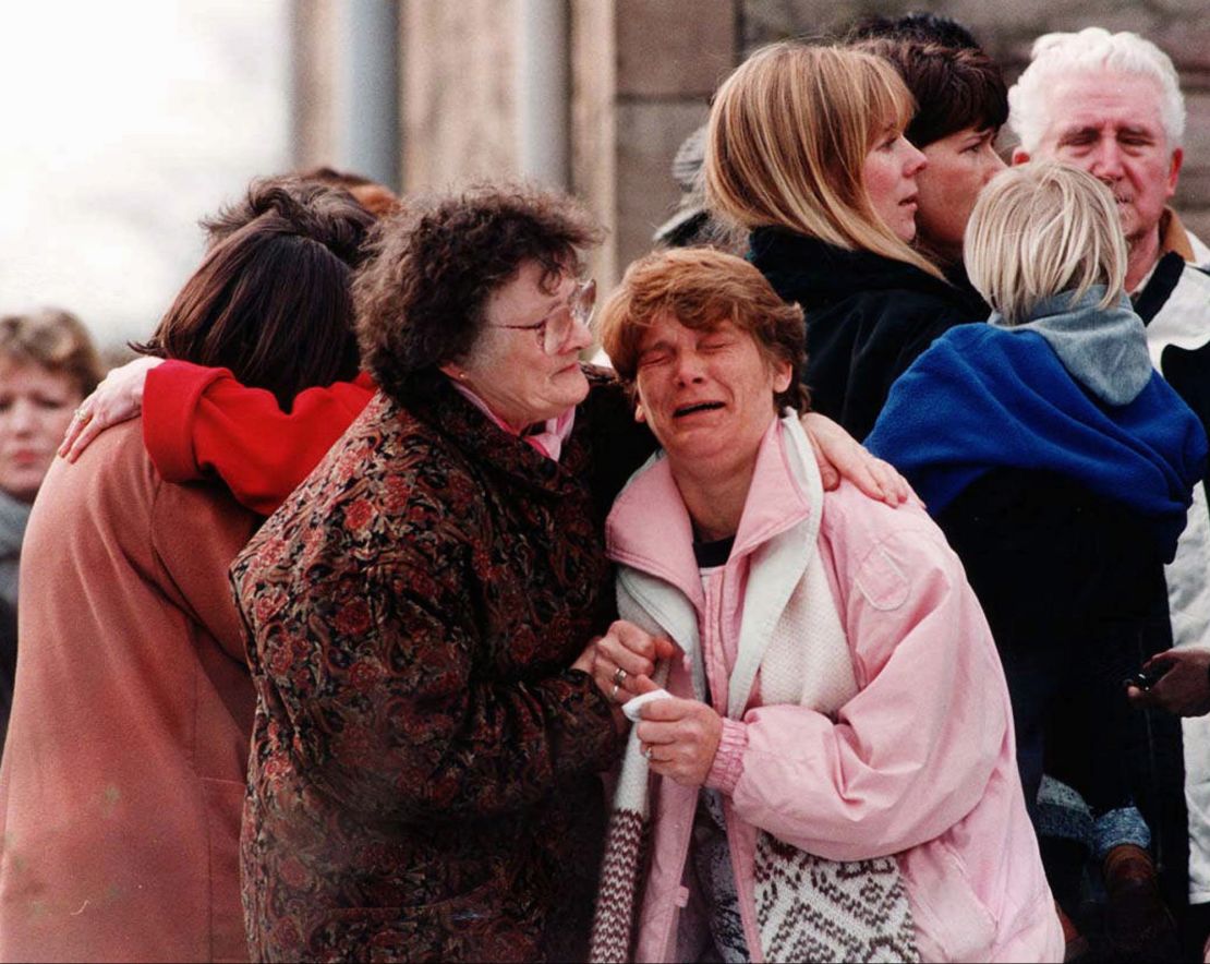 A group of relatives near the elementary school in Dunblane, Scotland, where a gunman killed 16 children and one teacher in 1996.  