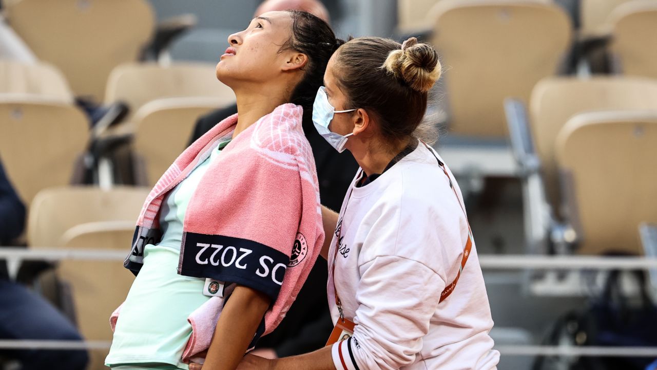 Zheng Qinwen of China is attended to during her match against Iga Swiatek of Poland at the French Open on May 30.