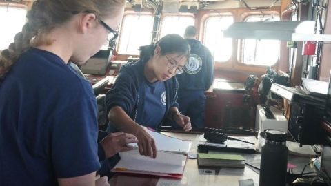Crewmembers aboard the US Coast Guard Cutter Myrtle Hazard stand watch on the bridge while underway in Oceania.