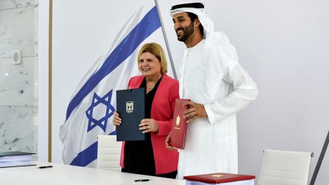 Israel's Minister of Economy and Industry Orna Barbivai and UAE Minister of Economy Abdulla bin Touq Al Marri present the free trade agreement they signed in Dubai, United Arab Emirates on May 31.  