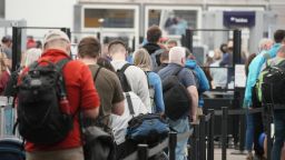 Travelers queue up at the north security checkpoint in the main terminal of Denver International Airport, Thursday, May 26, 2022, in Denver. 