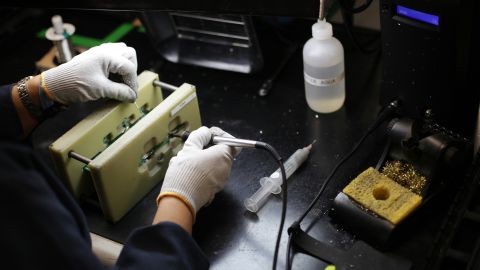 An A123 Systems employee solders a printed circuit board at the company manufacturing facility in Westborough, Massachusetts in 2012.
