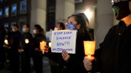 People attend a candlelight vigil for the eight victims of the mass shooting in Atlanta of March 16, and for the rise in anti-asian hate crimes, held on the steps of Queens Borough Hall, in the Queens borough of New York City, March 29, 2021. Eight people, six of asian descent, were killed in Atlanta, Georgia on March 16, when a gunman attacked three Asian run spas. 