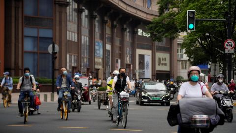 Residents cycle in the streets after Shanghai lifted its Covid-19 lockdown on Wednesday.