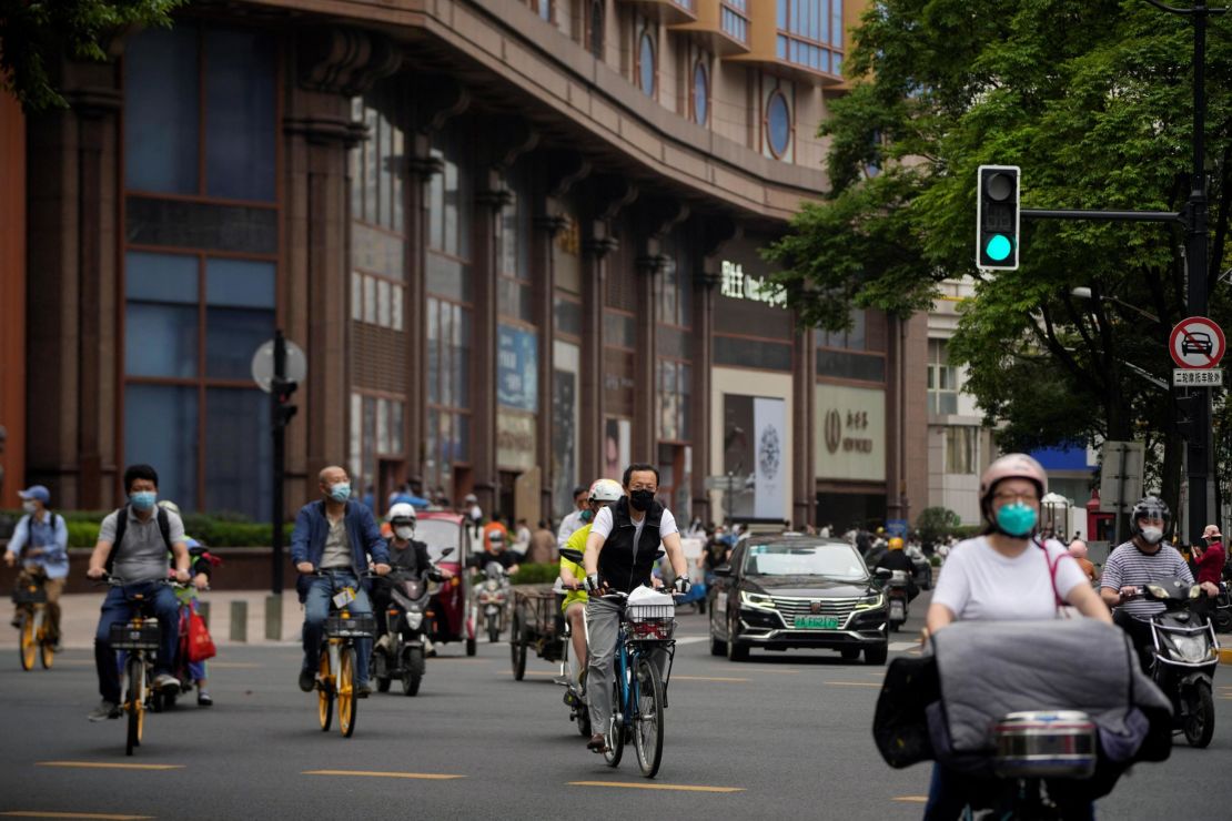 Residents cycle in the streets after Shanghai lifted its Covid-19 lockdown on Wednesday.