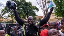 Kunle Adeyanju (C) celebrates with supporters after arriving at the Ikeja Rotary club in Lagos on May 29, 2022, after a 41 day trip from London, by motorbike, to raise funds and awareness for the End Polio campaign. (Photo by Benson Ibeabuchi / AFP) (Photo by BENSON IBEABUCHI/AFP via Getty Images)