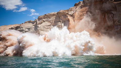 Rocks plunge into Lake Powell on Monday, May 30.
