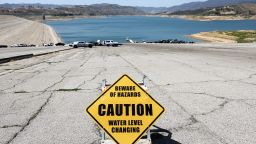 A caution sign is posted at the Castaic Lake reservoir in Los Angeles County on May 3, 2022 in Castaic, California. The reservoir, part of the State Water Project, is currently at 52 percent capacity, below the historic average of 60 percent. A water shortage emergency has been declared in Southern California with water restrictions beginning June 1st for 6 million residents amid drought conditions.