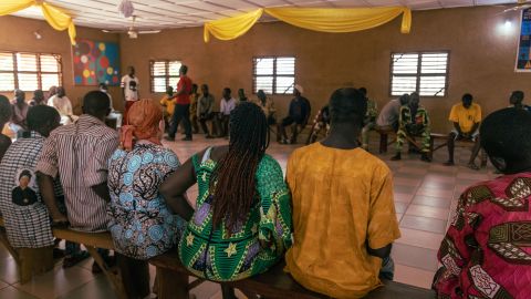 Ajoke participates in an art therapy session at St. Camille where the group listens to music and draws out their interpretations of it.