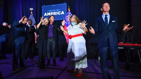Some evangelical leaders have become involved in politics. Here Ralph Reed, Dr. Alveda King, Journey keyboardist Jonathan Cain, personal pastor to the president Paula White Cain and others pray on stage during a July 2020 campaign event for then-President Trump in Alpharetta, Georgia.