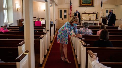 Tricia Melton speaks with a friend ahead of a service at Hopeful Baptist Church on Sunday, May 17, 2020, in Montpelier, Virginia. Public health officials sometimes clashed with church leaders who held in-person services in the early months of the pandemic.