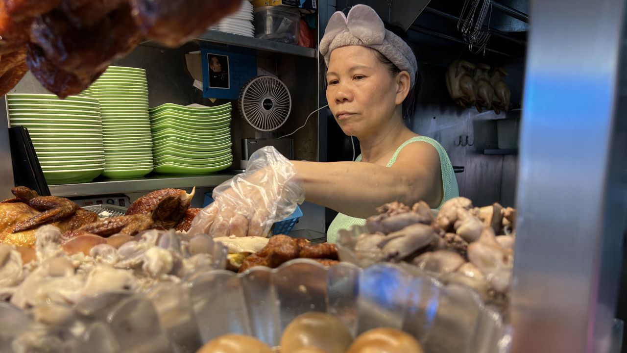 Chicken-rice seller Madam Tong prepares a dish for a customer.