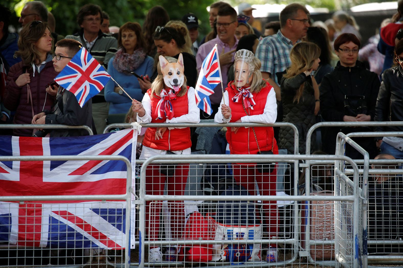 People wear masks of the Queen and one of her dogs as they attend jubilee celebrations on The Mall on Thursday.