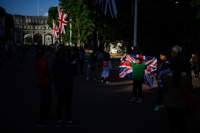 A boy poses with a Union flag on The Mall on Wednesday.